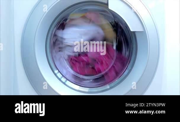 Close Up Industrial Washing Machine Washes Colored Clothing And White Close Up Industrial Washing Machine Washes Colored Clothing And White
