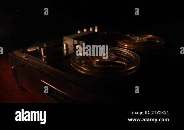 https://c8.alamy.com/comp/2tyxk54/old-vintage-reel-to-reel-player-and-recorder-on-dark-toned-foggy-background-analog-stereo-open-reel-tape-deck-recorder-player-with-reels-selective-focus-2tyxk54.jpg