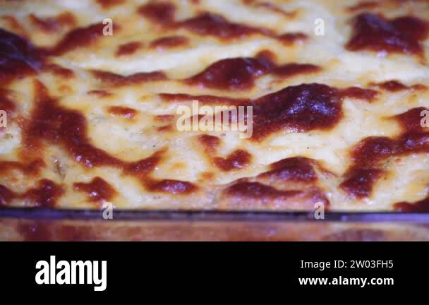 Greek moussaka dish recipe preparation. Zoom out shot on a transparent