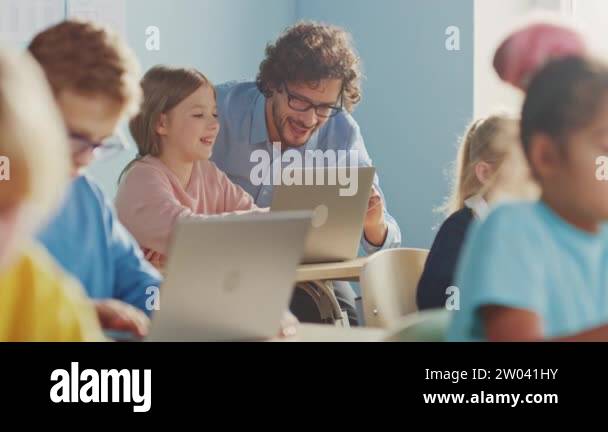 Elementary School Computer Science Class: Smart Girl Uses Laptop ...