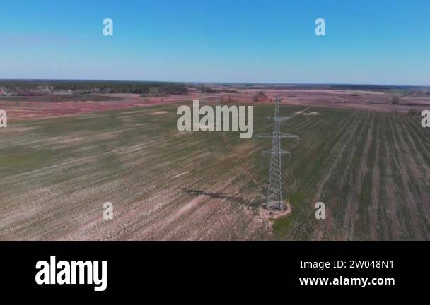 Electricity pylon and power lines in field. Energy substation ...