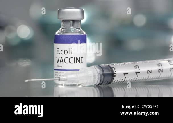 E.coli vaccine vial in medial lab with syringe place next to it slowly ...