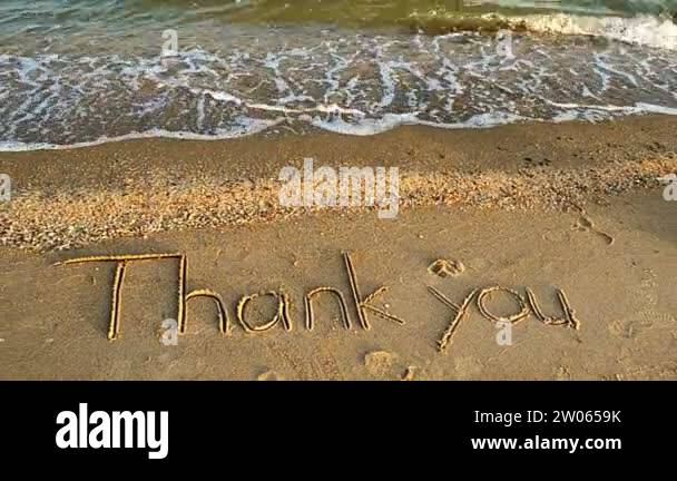 Thank you handwritten in sand on a beach. Shooting on the beach Stock ...