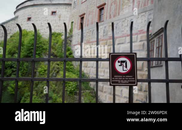 Metal fence with warning sign prohibiting climbing over fence, funny ...