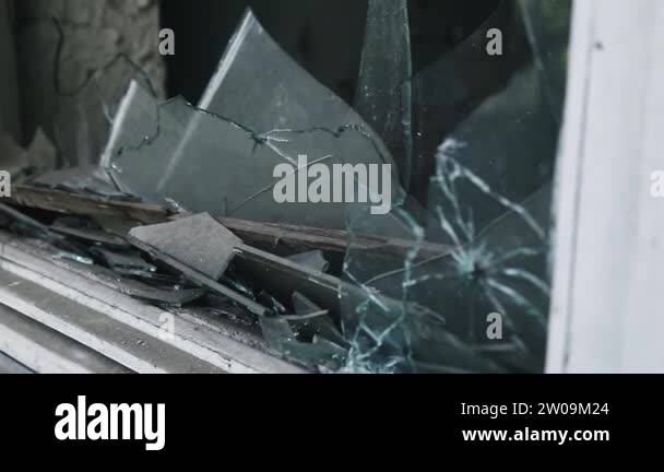 Bullet hole in the glass, a broken window after shelling, gun shot ...