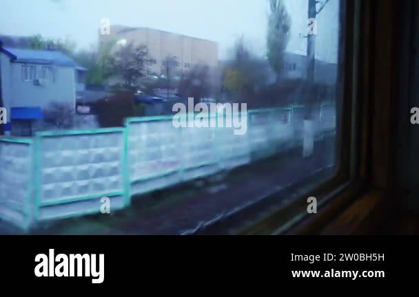 Railroad tracks view from fast moving train window. Raindrops on the ...