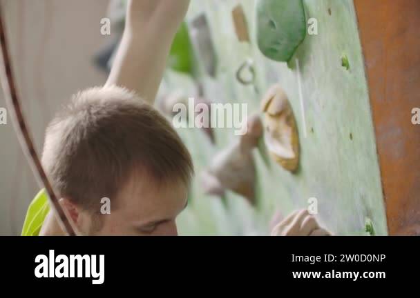 Boulder climber man exercising at indoor climbing gym wall. Training ...