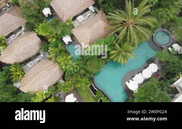 Aerial Drone Flight top down View of luxury hotel with straw roof ...