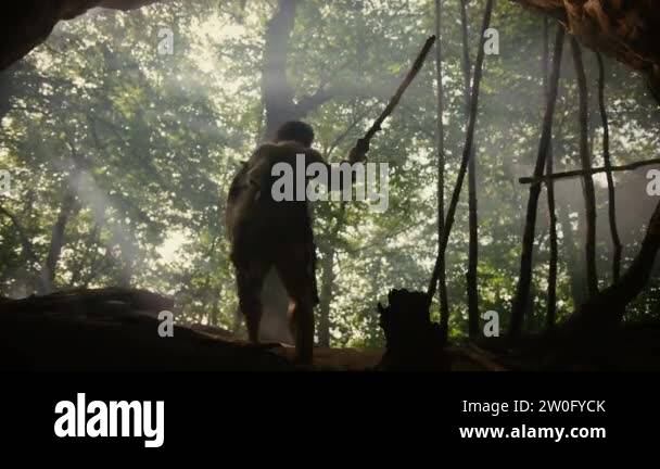 Primeval Caveman Wearing Animal Skin Holds Stone Tipped Spear, Stands