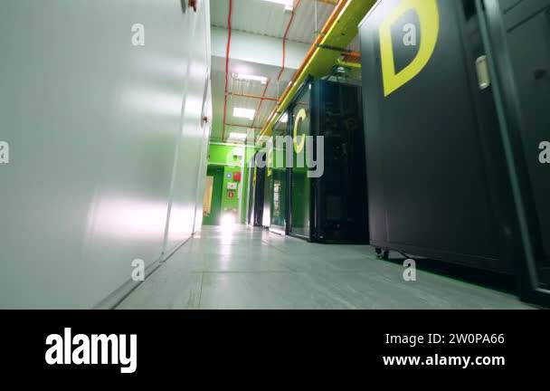 Main corridor of the server room with green walls. Servers in data ...