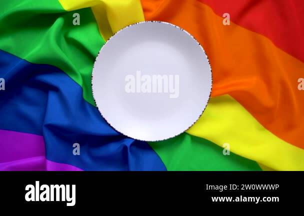 White plate on a rainbow flag LGBT flag of six colors for design ...