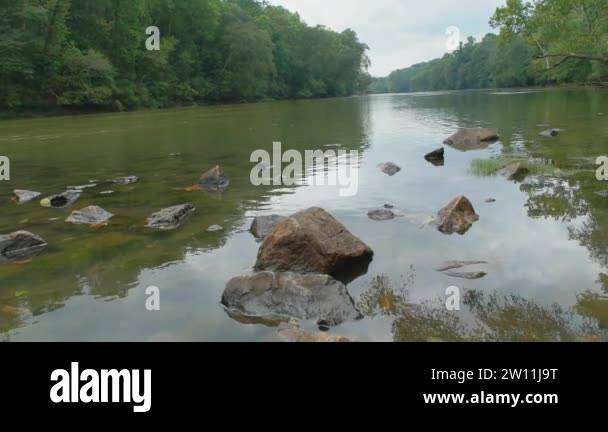Standing on the boat ramp out into the river panning with the flow of ...