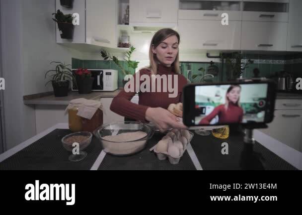 beautiful housewife-blogger writes recipe food on smartphone for