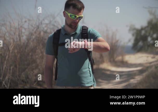 Man navigates use smartphone while day hiking using GPS device on a ...