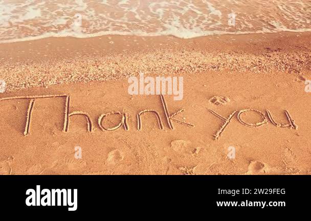 Thank you handwritten in sand on a beach. Shooting on the beach Stock ...