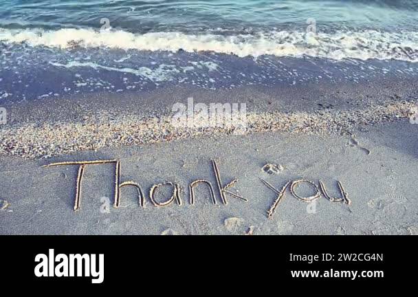 Thank you handwritten in sand on a beach. Shooting on the beach Stock ...