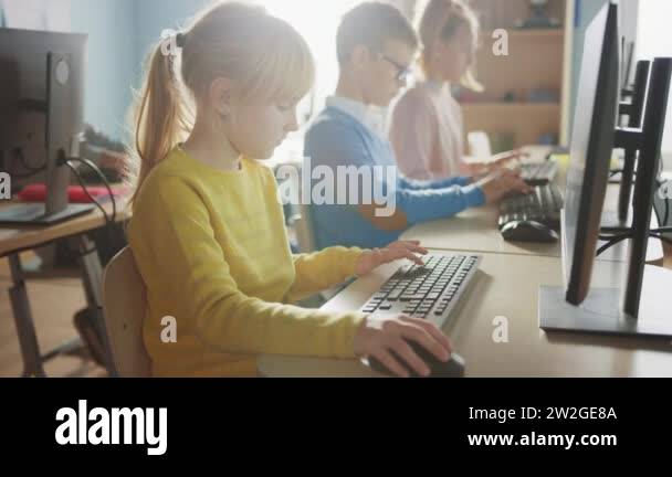 Elementary School Computer Science Classroom: Cute Little Girl Uses ...