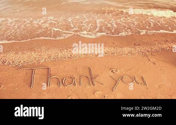 Thank you handwritten in sand on a beach. Shooting on the beach Stock ...