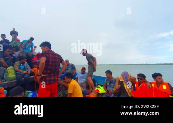 Bay of Bengal,Bangladesh-18.11.2020: People heavily loaded on a boat ...