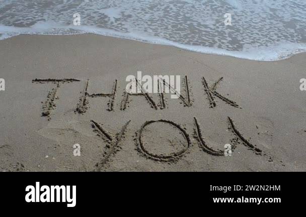 Thank you handwritten in sand on a beach. Shooting on the beach Stock ...