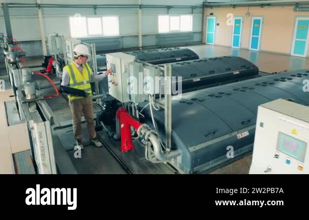 Wastewater treatment operator inspecting a water cleaning system using ...