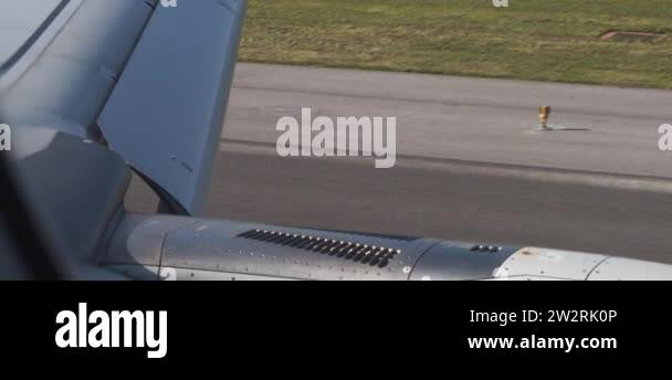 Airplane moving on the runway during take off, view of the wing flaps ...
