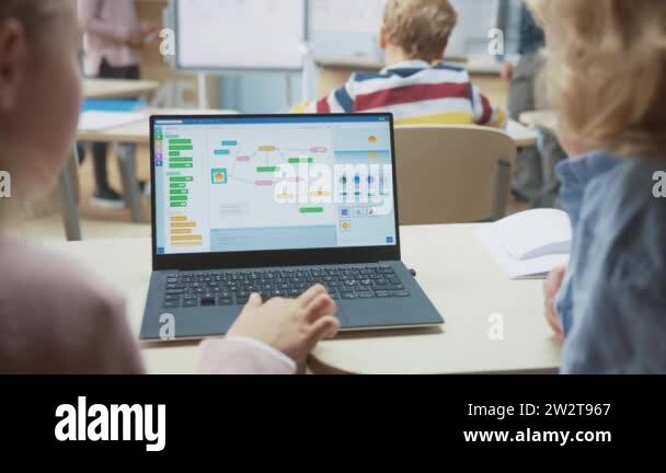 Elementary School Science Class: Over the Shoulder Little Boy and Girl ...