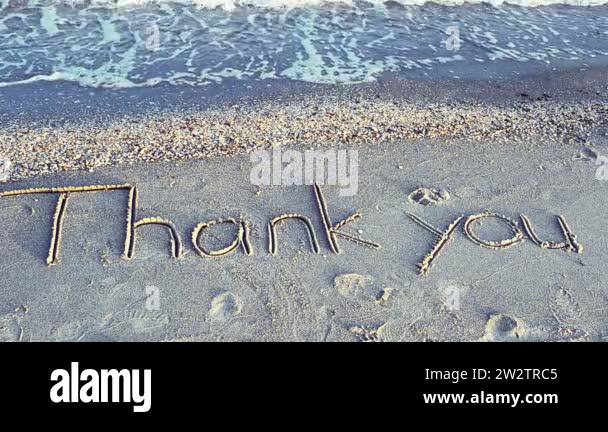 Thank you handwritten in sand on a beach. Shooting on the beach Stock ...