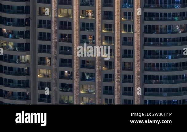 Night view of exterior apartment tower timelapse. High rise skyscraper ...