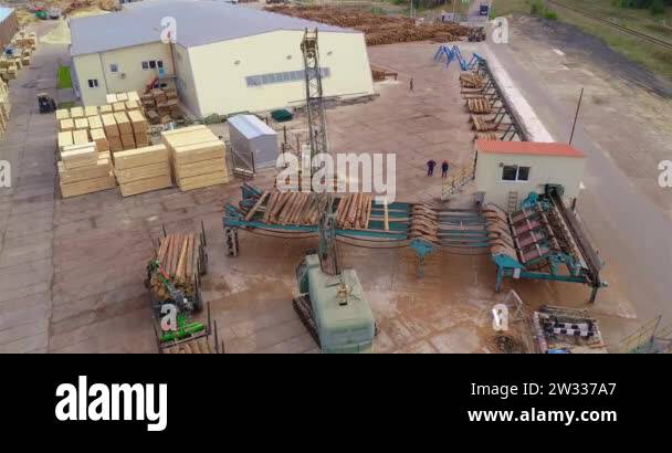 Modern sawmill aerial view, crane unloads logs on the conveyor. General ...