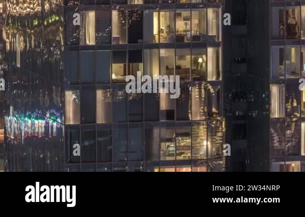 Night view of exterior apartment tower timelapse. High rise skyscraper ...