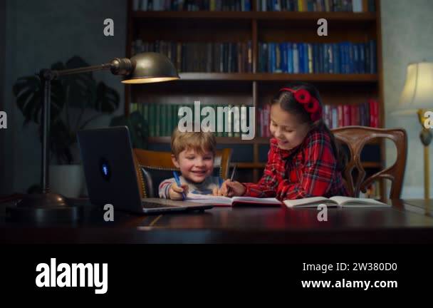 Siblings Writing Two preschool kids making online homework at home. Siblings writing ...