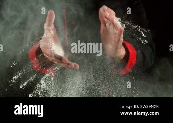 Super slow motion of chef clapping hands with flour. Filmed on high ...