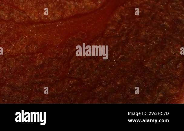 Liquid with the color of copper, iron, rust. Brilliant pigment in the ...