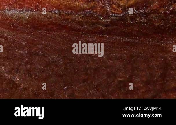 Liquid with the color of copper, iron, rust. Brilliant pigment in the ...