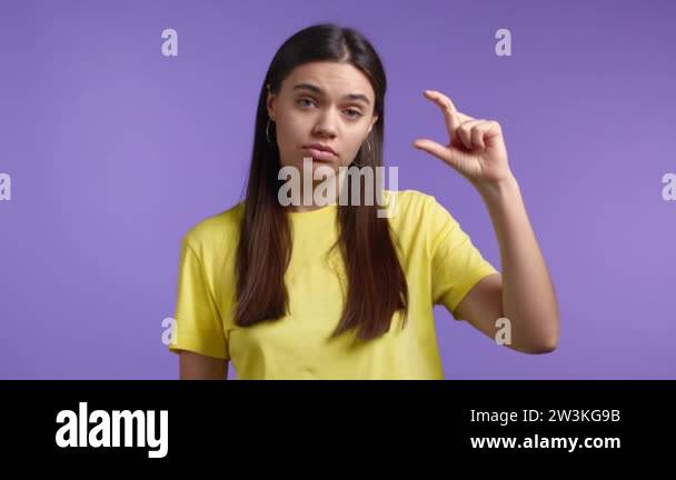 Young woman showing difference between invisible abstract subject or ...