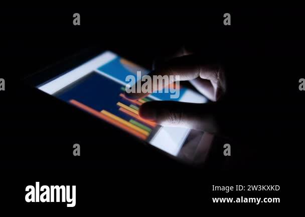 man hand analyzing charts on digital tablet, using self created chart ...