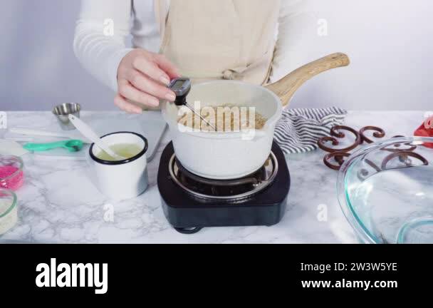 Step by step. Caramelizing sugar in a small cooking pot over the small ...