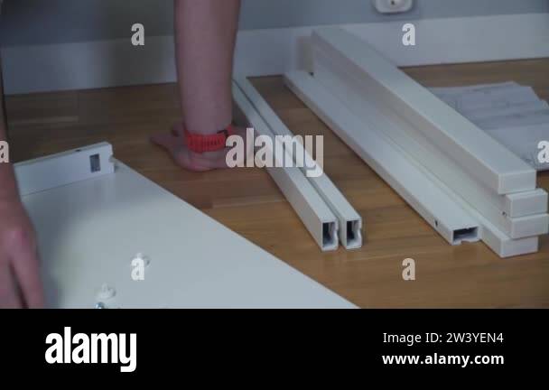 DIY white table assembly process at home. Furniture installation. New ...