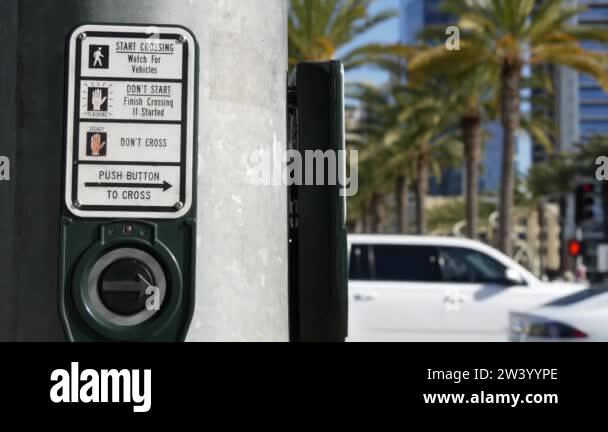 Traffic light button on pedestrian crosswalk, people have to push and