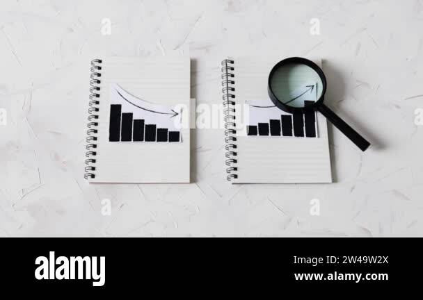 statistics concept, positive and negative trends on graphs on notebooks ...