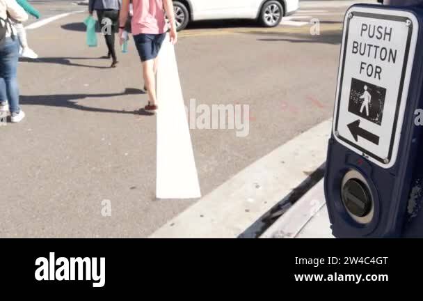 Traffic light button on pedestrian crosswalk, people have to push and