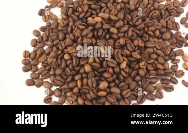 Close-up of the rotation of coffee beans. Roasted grains of aromatic ...