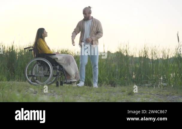 Wide shot of angry man returning wedding ring to handicapped woman and ...