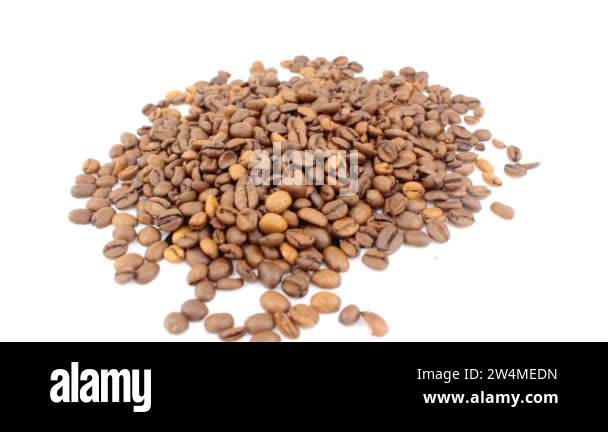 Close-up of the rotation of coffee beans. Roasted grains of aromatic ...