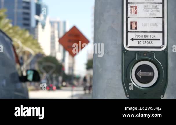 Traffic light button on pedestrian crosswalk, people have to push and
