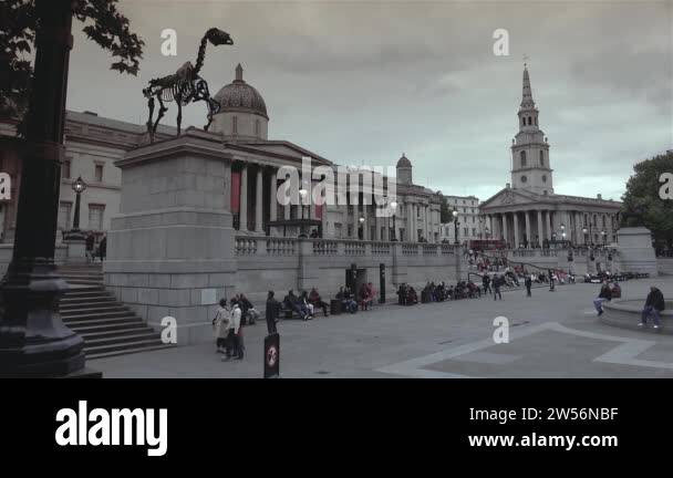 LONDON,UK, circa 2019 :People visit Trafalgar Square in London.One of
