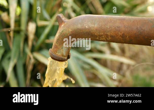 Spring water hand well pump with dirty contaminated water outlet with