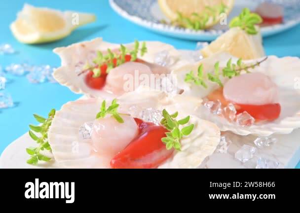 Chef preparing healthy gourmet food, seared scallops with caviar on on ...