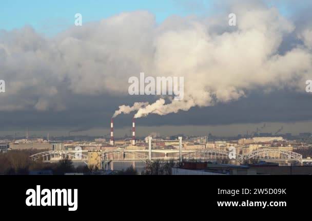 White smoke from pipes of a thermal power plant over city. The smoke ...